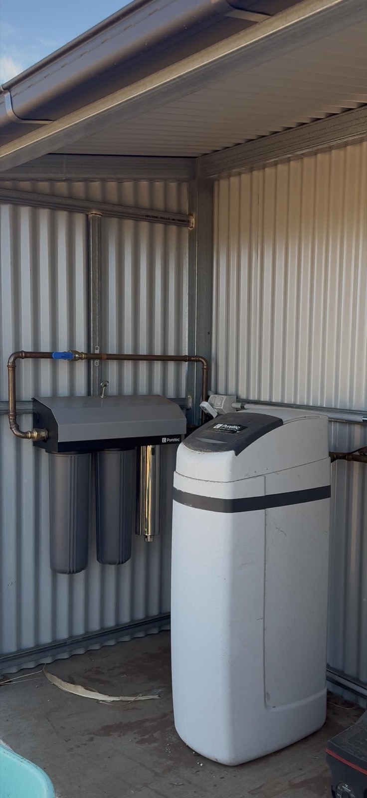 A water filtration and softening system installed in a shed by Spartan Plumbing & Gas