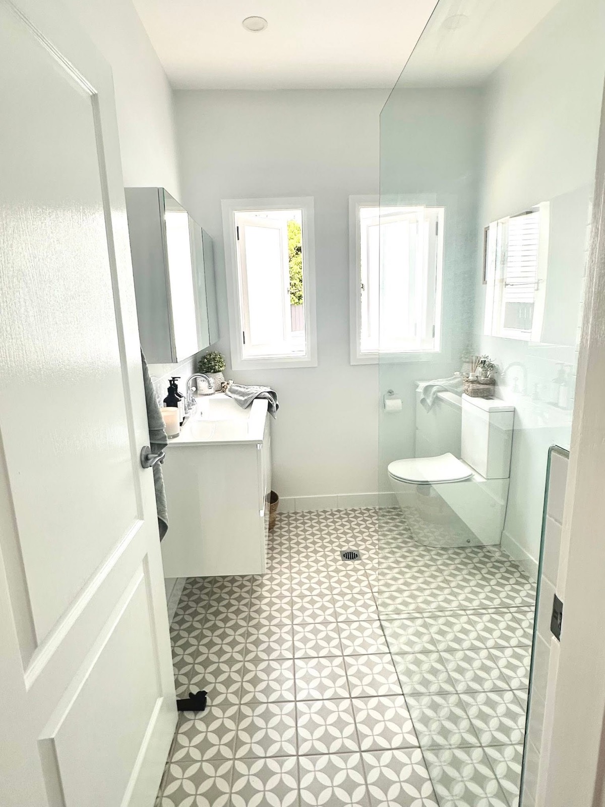 A finished bathroom with tiled floor completed by Spartan Plumbing & Gas
