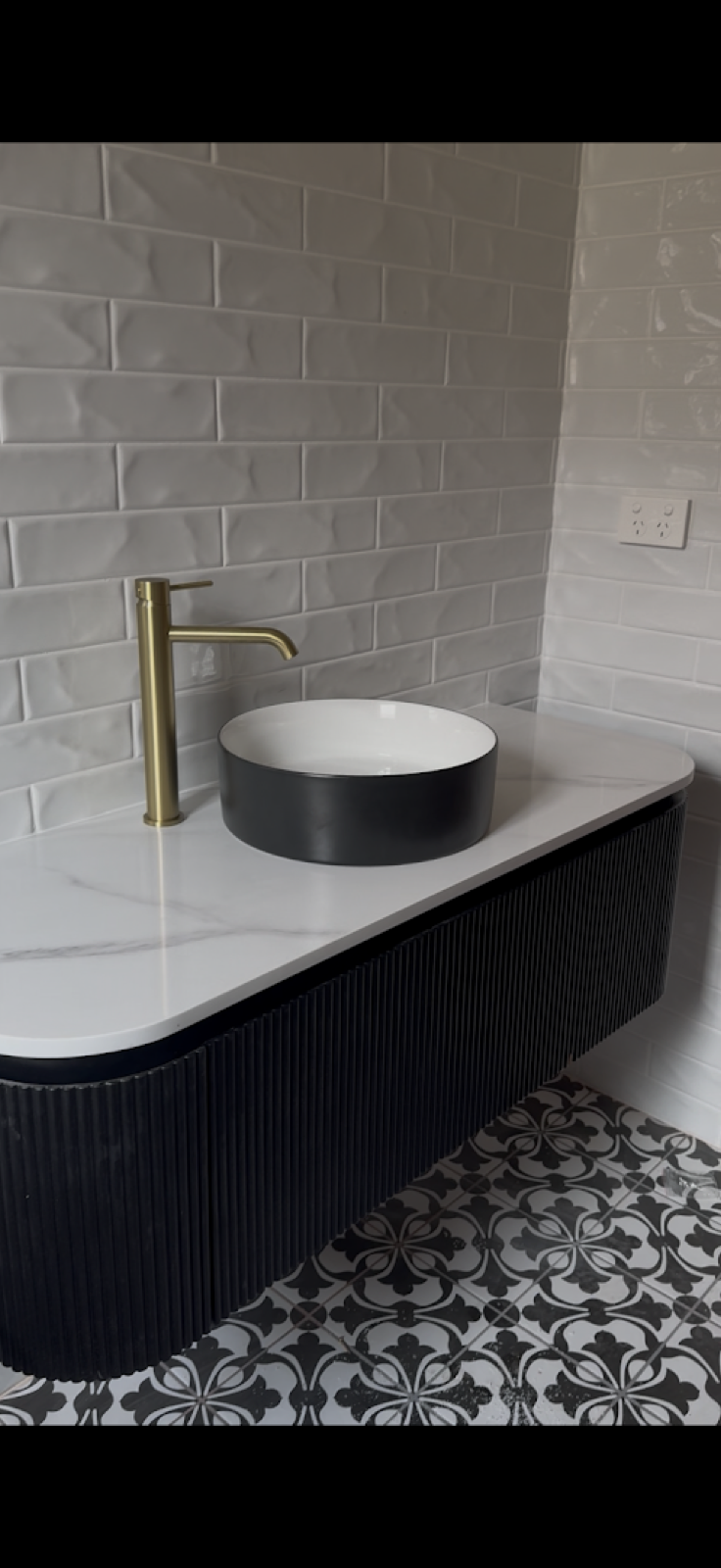 A bathroom vanity with gold tapware fitted by Spartan Plumbing & Gas